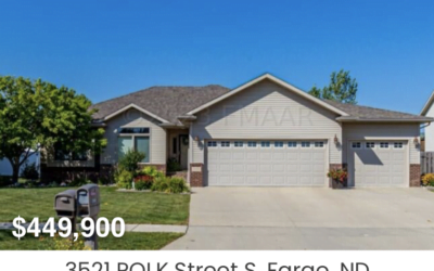 Single-story home with a three-car garage under a clear blue sky, overlaid with the price ‘$449,900’ and the address ‘3521 POLK Street S, Fargo, ND