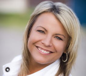 Headshot of Shannon Barnum, REALTOR® at Modern Market REALTORS®, smiling against a softly blurred outdoor background.
