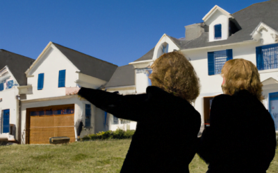 Two real estate clients or agents viewing a row of large suburban homes on a clear day, pointing at a house for sale.