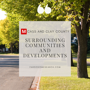 Tree-lined residential street in Cass and Clay County with overlay text ‘Surrounding Communities and Developments’, the Modern Market REALTORS® red-M logo, and fargohomesearch.com