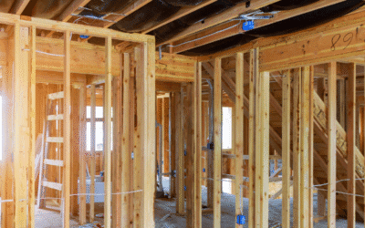 Framing of a new residential home under construction with exposed wood beams and electrical wiring